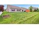 Spacious backyard featuring lush green grass, a fire pit, and a charming garden bed at 1893 Devonshire Ave, Avon, IN 46123