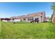 A well-manicured backyard with a fire pit, grill, and manicured lawn, perfect for outdoor entertaining at 1893 Devonshire Ave, Avon, IN 46123
