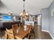 Open floor plan featuring dining area, living room with a large TV, and a modern kitchen at 1893 Devonshire Ave, Avon, IN 46123