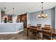 Inviting dining room featuring a stylish chandelier and seamlessly connected to the modern kitchen space at 1893 Devonshire Ave, Avon, IN 46123