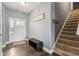 Welcoming entryway featuring hard wood floors, coat storage and convenient access to the staircase at 1893 Devonshire Ave, Avon, IN 46123