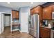 Well-equipped kitchen with stainless steel refrigerator and a view of the adjacent desk area at 1893 Devonshire Ave, Avon, IN 46123