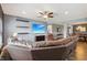 Bright living room open to dining area, featuring shelving, soft lighting, and hardwood floors at 1893 Devonshire Ave, Avon, IN 46123