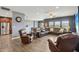 Comfortable living room with leather seating, a ceiling fan, and natural light from large windows at 1893 Devonshire Ave, Avon, IN 46123