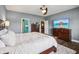 Main bedroom with hardwood floors, a large bed, and a view into an ensuite at 1893 Devonshire Ave, Avon, IN 46123