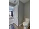 A well-lit bathroom with a modern toilet and wood-look floors adds comfort to the home at 19187 Outer Bank Rd, Noblesville, IN 46062