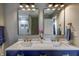 Chic bathroom highlighting a double vanity, quartz countertop, gold fixtures, and decorative mirrors at 19187 Outer Bank Rd, Noblesville, IN 46062