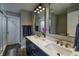 Elegant bathroom featuring a double vanity, quartz countertop, gold fixtures, and decorative mirrors at 19187 Outer Bank Rd, Noblesville, IN 46062