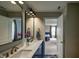 Stylish bathroom with double vanity, quartz countertop, gold fixtures, and a view into the bedroom at 19187 Outer Bank Rd, Noblesville, IN 46062