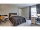 Bedroom features a comfortable bed with grey bedding and a cozy study corner at 19187 Outer Bank Rd, Noblesville, IN 46062
