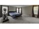 Spacious bedroom featuring an exercise machine, large windows, and neutral colored walls and carpet at 19187 Outer Bank Rd, Noblesville, IN 46062