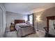 This bedroom boasts a comfortable bed, side table, study desk, and ample natural light at 19187 Outer Bank Rd, Noblesville, IN 46062