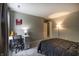 This bedroom with a desk area includes neutral walls, a poster and a cozy corner lamp at 19187 Outer Bank Rd, Noblesville, IN 46062