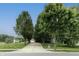 Long driveway lined with mature trees leading to the garage at 19187 Outer Bank Rd, Noblesville, IN 46062