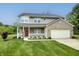 Charming two-story home with a welcoming front porch and manicured lawn at 19187 Outer Bank Rd, Noblesville, IN 46062