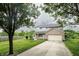 Two-story home with a well-manicured lawn, mature trees, and a long driveway leading to a two-car garage at 19187 Outer Bank Rd, Noblesville, IN 46062