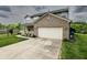 View of the driveway, garage, and landscaped yard of a well-maintained two-story home at 19187 Outer Bank Rd, Noblesville, IN 46062
