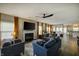Spacious living room with hardwood floors, a fireplace, comfortable furniture, and an open layout to the kitchen at 19187 Outer Bank Rd, Noblesville, IN 46062