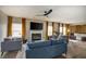 Modern living room featuring hardwood floors, a fireplace, comfortable seating, and abundant natural light at 19187 Outer Bank Rd, Noblesville, IN 46062