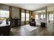 Inviting living room featuring hardwood floors, a wine rack, and large windows with natural light at 19187 Outer Bank Rd, Noblesville, IN 46062