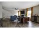 Open-concept living room with hardwood floors, a fireplace, stylish furniture, and access to a staircase at 19187 Outer Bank Rd, Noblesville, IN 46062