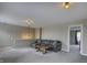 Cozy loft area with comfortable gray sofa, warm wood coffee table, and soft carpeting at 19187 Outer Bank Rd, Noblesville, IN 46062