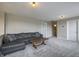 Relaxing loft area with plush gray sofa, wood coffee table, and neutral colored walls at 19187 Outer Bank Rd, Noblesville, IN 46062