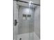 Modern bathroom featuring glass enclosed shower with white marble tiling, gold fixtures and shower head at 19187 Outer Bank Rd, Noblesville, IN 46062