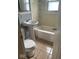 Bathroom featuring a white pedestal sink and a bathtub with shower at 1943 N Drexel Ave, Indianapolis, IN 46218