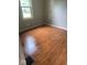 Bedroom featuring wood flooring, neutral walls, and natural light from a window at 1943 N Drexel Ave, Indianapolis, IN 46218
