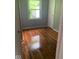 Bedroom with hardwood floors, closet, and window providing natural light at 1943 N Drexel Ave, Indianapolis, IN 46218
