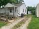 View of the home's side yard, showing the driveway and detached garage at 1943 N Drexel Ave, Indianapolis, IN 46218