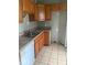 Functional kitchen with wood cabinets and stainless steel sink at 1943 N Drexel Ave, Indianapolis, IN 46218
