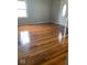 Living room featuring original hardwood floors and a large window at 1943 N Drexel Ave, Indianapolis, IN 46218