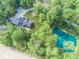 A stunning aerial view of the property, showcasing the house, lush greenery, a pond and surrounding landscape at 2004 Layton Rd, Anderson, IN 46011