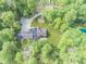 Gorgeous aerial view of an estate, with a large home, private driveway, pond, and abundant trees at 2004 Layton Rd, Anderson, IN 46011