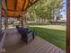 Inviting back porch with comfortable seating overlooking a lush, green backyard at 2004 Layton Rd, Anderson, IN 46011