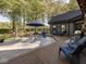 Backyard featuring a patio with outdoor seating, stone accents, and lush trees at 2004 Layton Rd, Anderson, IN 46011
