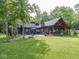 Expansive backyard featuring a well-manicured lawn and covered patio for outdoor living at 2004 Layton Rd, Anderson, IN 46011