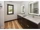 Modern bathroom featuring a double sink vanity with illuminated mirrors and ample natural light at 2004 Layton Rd, Anderson, IN 46011