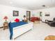 Bright bedroom features a sitting area, soft carpet, and a comfortable red leather sofa at 2004 Layton Rd, Anderson, IN 46011