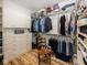 Spacious walk-in closet with ample shelving, cabinetry, wooden floor, and hanging storage space at 2004 Layton Rd, Anderson, IN 46011