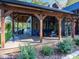 A well-appointed covered deck featuring wooden beams and ample seating for outdoor relaxation and entertaining at 2004 Layton Rd, Anderson, IN 46011