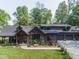 Attractive home showcasing stone accents, a covered porch, and a three-car garage on a manicured lawn at 2004 Layton Rd, Anderson, IN 46011