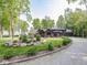 Stunning home featuring stone accents, a three-car garage, and professionally landscaped grounds for curb appeal at 2004 Layton Rd, Anderson, IN 46011