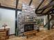 A striking stone fireplace complemented by hardwood floors and an adjacent staircase leading to the upper level at 2004 Layton Rd, Anderson, IN 46011