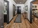 Inviting hallway with wood-paneled ceiling, doors leading to rooms, bench, and view of bedroom at 2004 Layton Rd, Anderson, IN 46011