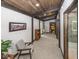 Well-lit hallway featuring hardwood accents, neutral walls, and tasteful decor at 2004 Layton Rd, Anderson, IN 46011