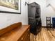 Functional laundry room features stacked washer/dryer, a wooden dresser, and artwork on the wall at 2004 Layton Rd, Anderson, IN 46011