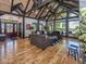Open-concept living room boasting hardwood floors, large windows, vaulted ceilings, and a stone fireplace feature at 2004 Layton Rd, Anderson, IN 46011